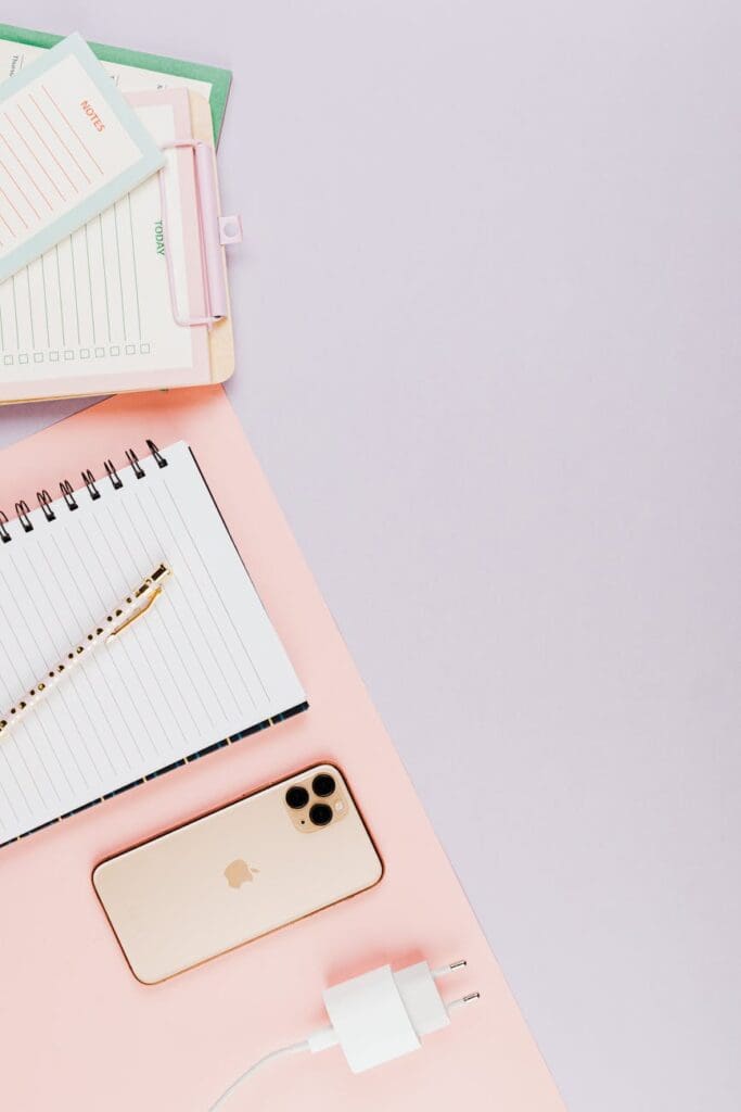 gold smartphone and writing materials
